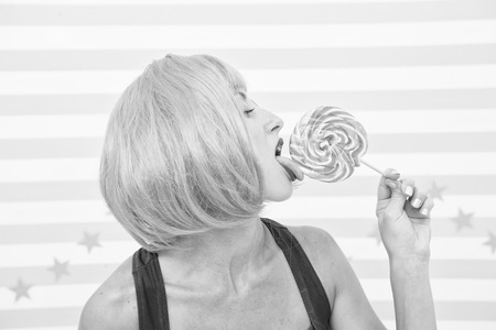 sexy crazy girl lick lollipop. desire. crazy girl love lollipop. sexy girl eating candy. just one kiss. true desire. woman with crazy look having orange hair. perfect viewの写真素材