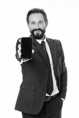 Businessman formal suit holds smartphone. Man bearded businessman use modern mobile phone. Checking email or sending message. Smartphone gives opportunities. Business communications.の写真素材
