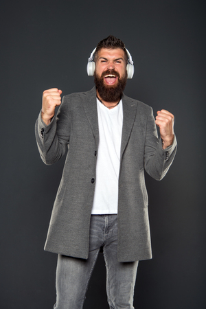 Hipster wear modern technology gadget headphones. Excellent sound. Music library concept. Walking with music. Lifestyle urban citizen. Music always with me. Man listening music wireless headphones.の写真素材