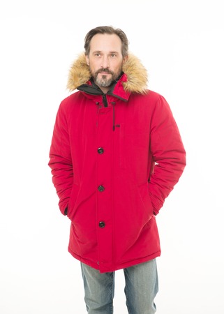 Feeling warm and comfortable. Bearded man wearing hooded jacket. A stylish winter garment protects...