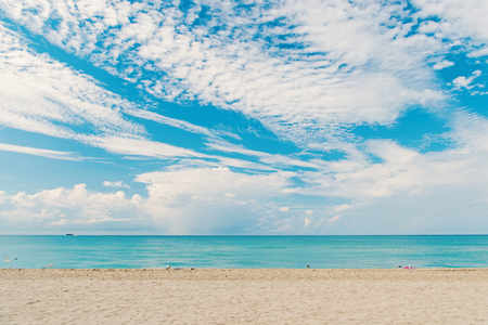 South miami beach . Sea beach with white sand and blue water in miami, usa. Seascape on cloudy sky. Summer vacation on tropical resort. Discovery or adventure and wanderlust.の写真素材