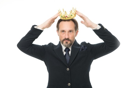 Getting all noble. Mature businessman wearing crown. Senior man representing power and triumph. Success in business. King of style. Achieving victory and success. Fit for a king. Business king.の写真素材