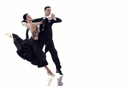 ballroom dance couple in a dance pose isolated on white background. ballroom sensual proffessional dancers dancing walz, tango, slowfox and quickstep ballroom couple dance professionalの写真素材