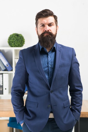 Bearded man boss. Mature hipster with beard. Confident brutal man boss. Business. Modern businessman. Businessman in formal suit. Serious man. Male fashion in business office. Boss and employee.の写真素材