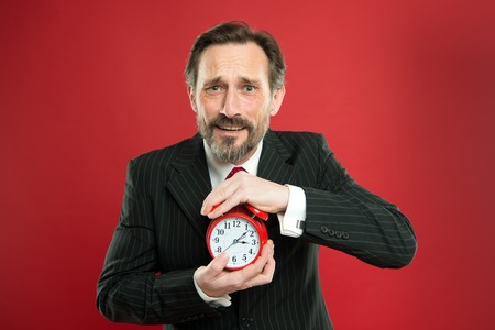 Time management skills. How much time left till deadline. Manager with alarm clock. Man bearded...