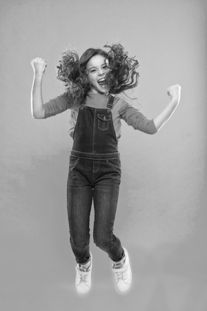 International childrens day. small kid fashion. small girl child with perfect hair. Happy little girl. Beauty and fashion. Childhood happiness. Add some action to your life.の写真素材