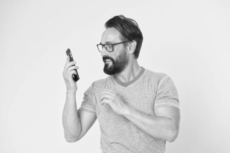 Hipster cheerful use smartphone. Man happy user of modern smartphone. Stay in touch with modern smartphone. Join online community. User friendly concept. Man excited about mobile phone opportunities.の写真素材
