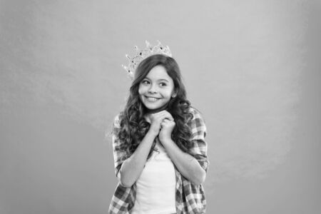 Girl cute baby wear crown while stand blue background. Become princess concept.の写真素材