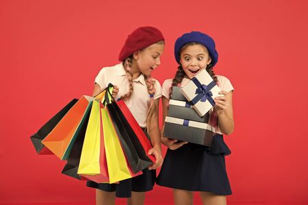 Small children with paper bags and wraps after shopping.の写真素材