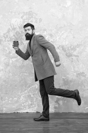 Mature businessman drink coffee on go.の写真素材