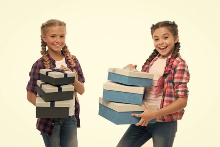 Kids little girls with braids hairstyle hold piles gift boxes.の写真素材