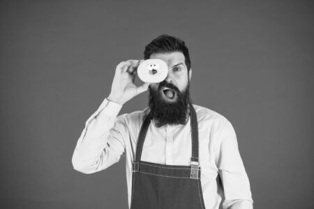 Calorie. Chef feel hunger. Calorie counting. Diet and healthy food. gain calorie. Bearded man in chef apron. Chef man in cafe. Food calorie. baker hold donut. Funny hipster chef. Cook at work.の写真素材