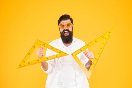 Smart student. Back to school. College university education. Man math lesson. Bearded nerd triangle. Geometry teacher. Student using measuring instrument. Engineering architecture faculty studentの写真素材