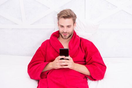 Morning rituals. Man hipster surfing internet social networks. Online communication. Mobile dependence. Social networks communication. Digital communication. Check email. Chatting with friendの写真素材