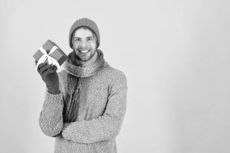 Winter fashion knitted clothes. Knitted accessories as hat and scarf. Man knitted hat gloves and scarf winter fashion. Man wear knitted accessory turquoise background. Winter accessories conceptの写真素材