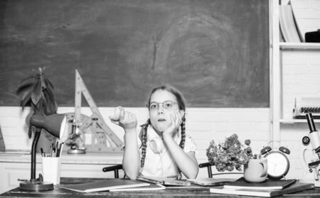 Healthy food. small girl ready to eat apple. Smart child concept. healthy eating is good. back to school. Einstein. small genius child in classroom. Lunch time. digital age with modern technologyの写真素材