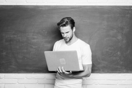 Student learn programming language. School teacher programming with laptop. Handsome man use modern technology. Digital technology. Apply online course for programmers. Programming web developmentの写真素材