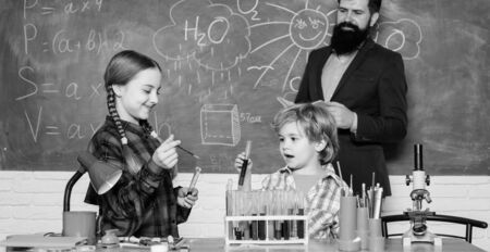 Confident medical experts. happy children teacher. doing experiments with liquids in chemistry lab....