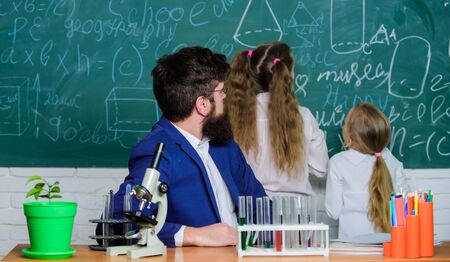 School teacher of biology. Man bearded teacher work with microscope and test tubes in biology classroom. Explaining biology to children. How to interest children study. Fascinating biology lessonの写真素材