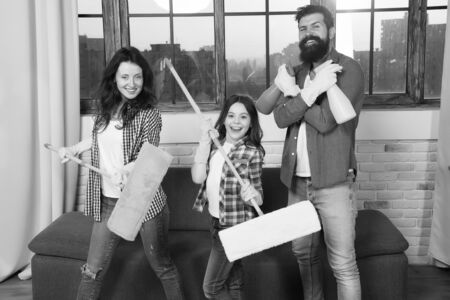 Expert house cleaning service you can trust. Family cleaning house. Happy family hold cleaning...