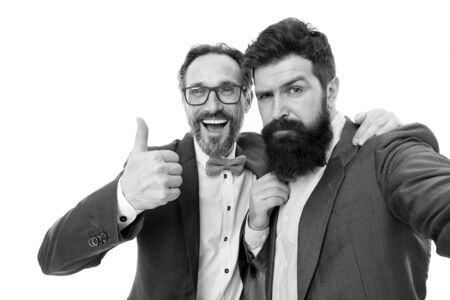 Sealing a deal. collaboration and teamwork. partnership of boss men isolated on white. mature men have own business. bearded businessmen in formal suit. business meeting. team success. High-fiveの写真素材