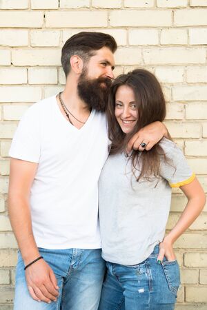 Just hang out together. Couple in love. Family couple hugging on brick wall background. Bearded man and sexy woman cuddling. Sensual couple together. Family day. Careful hug of loving peopleの写真素材
