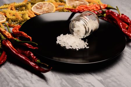 salt on black ceramic plate with ingredients