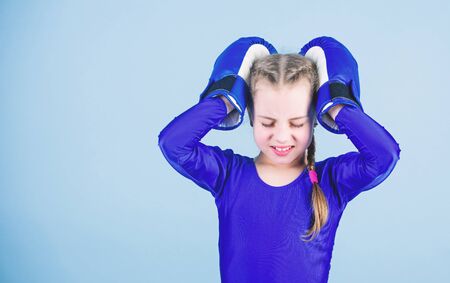 Risk of injury. Rise of women boxers. Girl cute boxer on blue background. With great power comes great responsibility. Boxer child in boxing gloves. Female boxer change attitudes within sportの写真素材