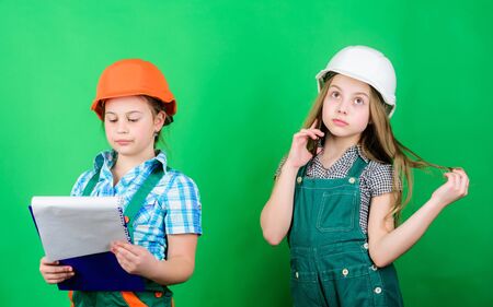 Future profession. Kids girls planning renovation. Initiative children girls provide renovation their room green background. Renovation plan. Home improvement activities. Builder engineer architectの写真素材