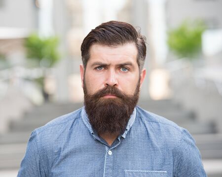 Feeling manly. Caucasian guy. Styling beard and moustache. Facial hair treatment. Hipster with beard brutal guy. Beard grooming. Brutality and beauty. Masculinity concept. Barber shop beard groomingの写真素材