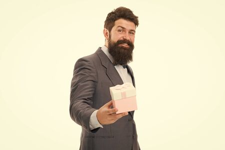 Nice present. Gift for spouse. Romantic surprise. Man formal suit hold gift box white background. Love and romantic feelings concept. Valentines day gift. Man with beard celebrate valentines dayの写真素材