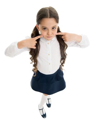 Keep silence. Strict school rules. September time to study. Girl cute pupil on white background. School uniform. Back to school. Student little kid adores school. Pupil of first grade. Silent childの写真素材