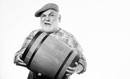 oktoberfest festival. brewery for maturing alcohol. Homemade wine. Man bearded senior carry wooden barrel for wine. Fermentation product. Retro man with a beer barrel. Barman. wooden barrelの写真素材