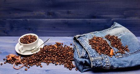 Inspiration and energy charge. Cup full coffee brown roasted bean blue wooden background. Fresh roasted coffee beans. Coffee shop concept. Cafe drinks menu. Coffee break and relax. Caffeine conceptの写真素材