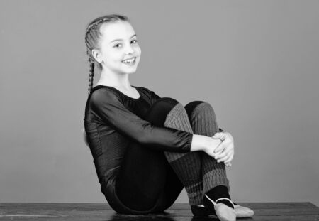 Minute to relax. Rhythmic gymnastics sport combines elements ballet dance. Girl little gymnast sports leotard. Physical education and gymnastics. Flexible body. Rhythmic gymnastics girlish sportの写真素材