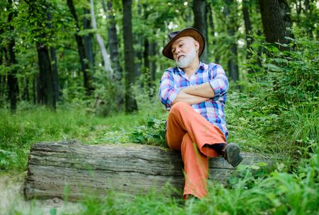 Freak healer. Folk magic. Person purported magical abilities. Magician in forest. Woodman magician concept. Mature man with beard in hat. Wise old man. Herbal remedies. Supernatural or superstitiousの写真素材