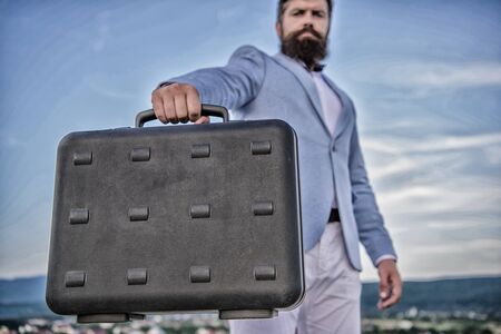 Business man formal suit carries briefcase sky background. Businessman presenting business case....