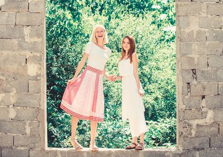 Friendship concept. Girls friends summer dress outfit nature background. Carefree youth friends hang out outdoors. Friendly relations. Summer rest. Summer vacation and relax. Revelation and sincerityの写真素材