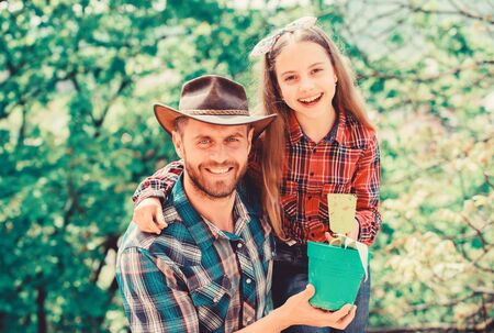 Plant your favorite veggies. Planting season. Family garden. Maintain garden. Planting flowers. Family dad and daughter planting plants. Transplanting vegetables from nursery or gardening centerの写真素材