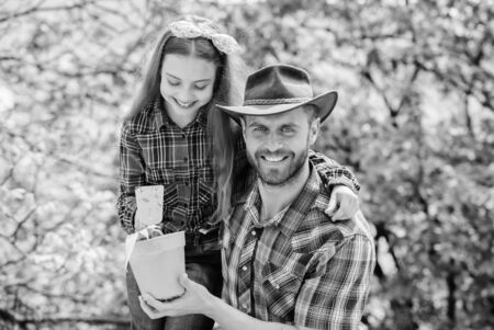 Flowers expert. ecology environment. soils and fertilizers. little girl and happy man dad. earth day. new life. family farm. agriculture. father and daughter on ranch. spring village countryの写真素材