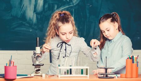 Really busy. students doing biology experiments with microscope. Little children at laboratory. Little kids learning chemistry in school lab. Chemistry microscope. Lab microscope. childrens dayの写真素材