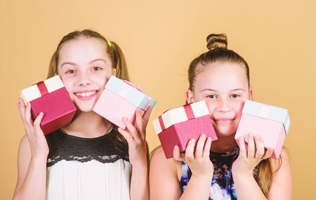 Full shopping. children. Little sisters with gift. Happy birthday. Holiday celebration. Boxing day. Christmas shopping. Surprise. Family sisterhood congratulation. Small girls with present boxの写真素材