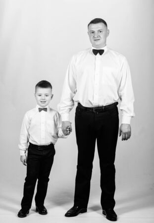 tuxedo style. PR manager. Wedding party. happy child with father. business meeting. small boy with dad gentleman. family day. male fashion. parenting. fathers day. father and son in formal suitの写真素材