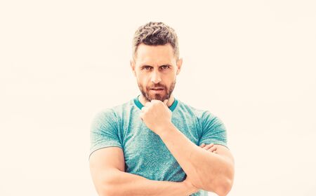 man athlete in blue sport tshirt. sportswear fashion. muscular male with beard. thoughtful man isolated on white. sportsman with athletic body. coach in fitness gym. after workout. Relax after trainの写真素材