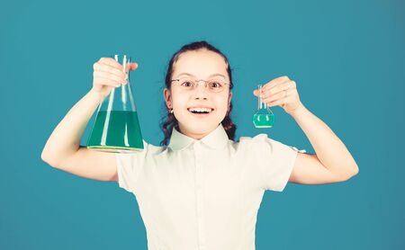Schoolgirl with chemical liquids. Childhood and upbringing. Knowledge and information. Experimenting a bit. Small kid study. Education concept. Chemistry fun. Basic knowledge. Knowledge dayの写真素材