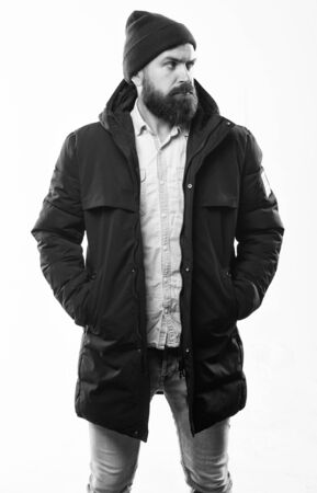 Guy wear hat and black winter jacket. Hipster style menswear. Hipster outfit. Stylish and comfortable. Man bearded hipster posing confidently in warm black jacket or parka. Hipster modern fashionの写真素材