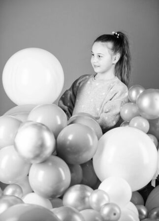 Obsessed with air balloons. Happiness positive emotions. Having fun. Balloons theme party. Girl play with air balloons. Birthday party. Childrens day. Carefree childhood. All those balloons for meの写真素材