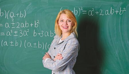 Back to school concept. Working conditions which prospective teachers must consider. Woman smiling educator classroom chalkboard background. Working conditions for teachers. She likes her jobの写真素材