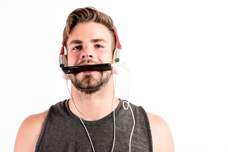 Inspiring music concept. Modern earphones. Music application smartphone. Listen music for motivation and inspiration. Audio quality. Man handsome unshaven hipster listen music using headphones gadgetの写真素材
