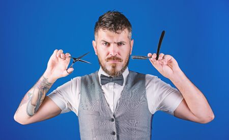 unshaven barber in bow tie. businessman grooming in morning. perfect beard. Male fashion. Bearded hipster hold shaving blade. barbershop master with scissors. barber tools. Clean and dry shavingの写真素材